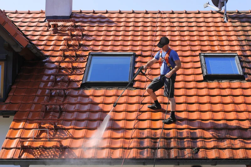 A tiled roof being pressure cleaned