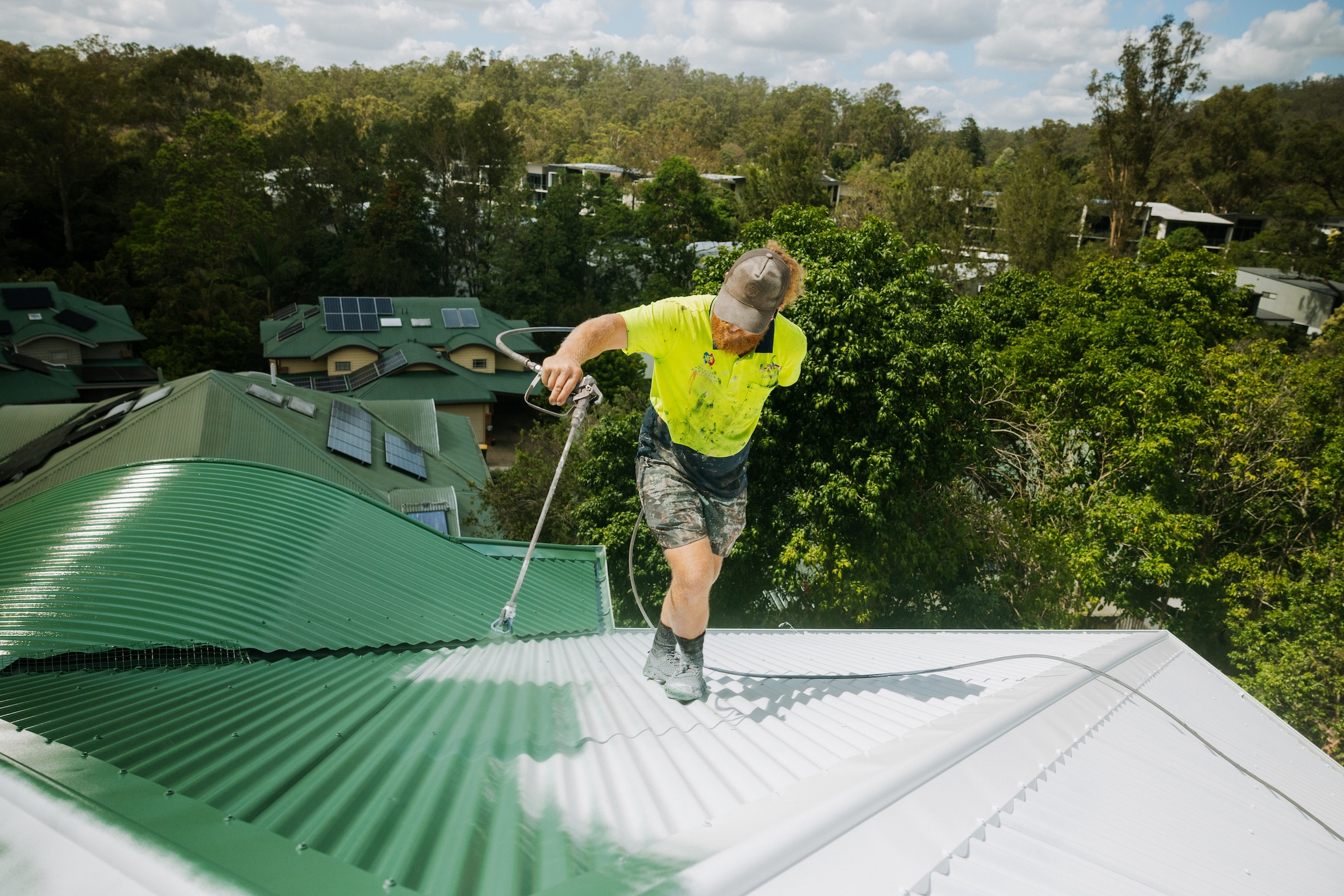 Protective coating being sprayed onto a metal roof